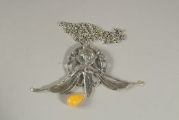 A SILVER NOUVEAU GIRL AND AMBER DROP PENDANT.