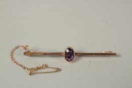 A 9ct GOLD BAR BROOCH.