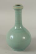 A CHINESE CELADON GLAZE PORCELAIN VASE. 26.5cms high.