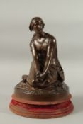 HENRI-MICHEL-ANTOINE CHAPU. A GOOD BRONZE OF A YOUNG SEATED LADY, hands crossed, on a circular base.