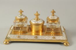 A GOOD GILT BRONZE INKWELL with two square silver bottles and holder. 21cms long.