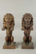 A PAIR OF SEATED BRONZE LIONS on square bases.