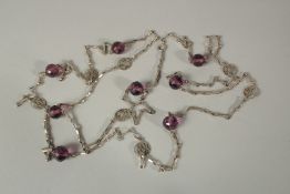 A VERY LONG VICTORIAN SILVER AND AMETHYST CHAIN. 140cms long.