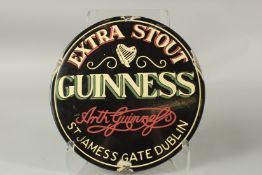 A GUINNESS EXTRA STRONG ENAMEL SIGN. 30cms diameter