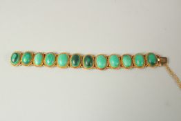 A GOLD (TESTS AS 18ct) AND TWELVE STONE MALACHITE BRACELET.