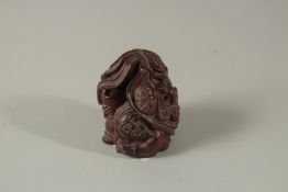 A CARVED HARDWOOD FIGURE AND A DRAGON NETSUKE. Signed. 5cms.