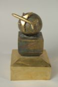 A BRONZE AIRCRAFT FLYING ROUND on a square base. 22cms high.