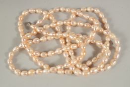 A LONG PEARL CHAIN, 150cms, in a velvet bag.
