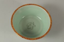 A CHINESE LONGQUN WARE BOWL, with incised characters to the base. 20cms diameter.