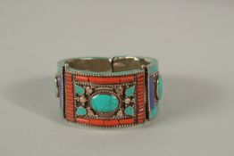 A CORAL AND TURQUOISE SET BANGLE.