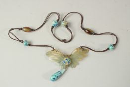 ELIZABETH BONTE, CIRCA 1900. A GOOD CARVED HORN AND ENAMEL PENDANT on a double rope. Signed.