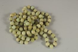 A LONG STRING OF CELADON BEADS. 120cms long.