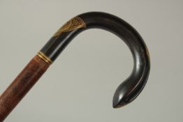 A WALKING STICK with metal gilded handle.