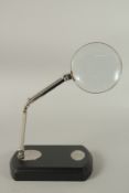 A MAGNIFYING GLASS ON A STAND.