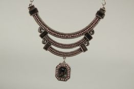 A SILVERED NECKLACE AND PENDANT.