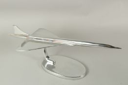 A LARGE CHROME MODEL OF CONCORDE on an oval base. 55cms long.