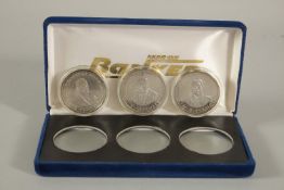 THREE SOVIET COINS in a blue velvet box.