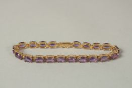 A 9ct GOLD AMETHYST LINE BRACELET.