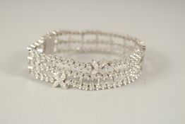 A SUPERB RUSSIAN .750 WHITE GOLD THREE ROW BRACELET, set with two flowers. 18cms long. 40grams.
