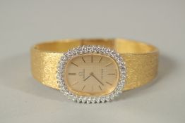 A LADIES' 18ct GOLD DIAMOND SET OMEGA WRISTWATCH in its' original case and white outer card.