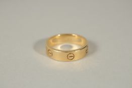 A CARTIER YELLOW GOLD RING in a Cartier red box.