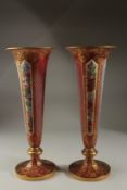 A VERY GOOD PAIR OF BOHEMIAN TAPERING RUBY GLASS VASES with gilt decoration and painted with