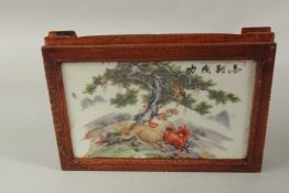 A CHINESE RECTANGULAR PORCELAIN PLAQUE in a wooden stand, decorated with horses. 27cms long.