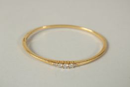 AN 18ct GOLD DIAMOND SET BANGLE.