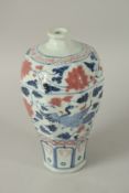 A CHINESE UNDERGLAZE RED AND BLUE PORCELAIN MEIPING VASE, decorated with peacocks and flora. 28cms