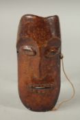 A SOUTH SEAS CARVED BONE MASK. 20cms long x 8cms wide.