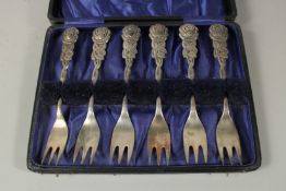 A SET OF SIX .900 SILVER ROSE DESIGN CAKE FORKS in a fitted case.