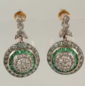 A PAIR OF UNHALLMARKED ROSE GOLD AND SILVER TOPPED TARGET STYLE DROP EARRINGS SET WITH CALIBRE