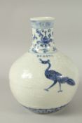 A CHINESE BLUE AND WHITE PORCELAIN VASE, decorated with peacocks and carved with flowers. 29cms