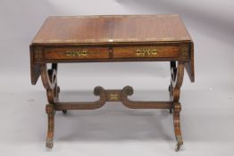 A GOOD REGENCY ROSEWOOD SOFA TABLE in the manner of GEORGE BULLOCK, with crossbanded top, brass