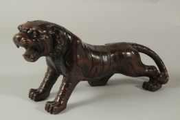 A GOOD BRONZE TIGER. 32cms long.