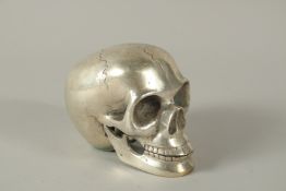 A SILVER PLATED SKULL. 11cms.