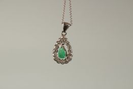 AN 18ct WHITE GOLD, EMERALD AND DIAMOND PENDANT AND 9ct GOLD CHAIN.