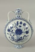 A CHINESE BLUE AND WHITE PORCELAIN FLORAL MOON FLASK, with twin handles. 28cms high.