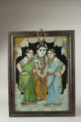 A LARGE 19TH CENTURY INDIAN TANJORE REVERSE GLASS PAINITNG of Krishna and two ladies, 69cm x 54cm