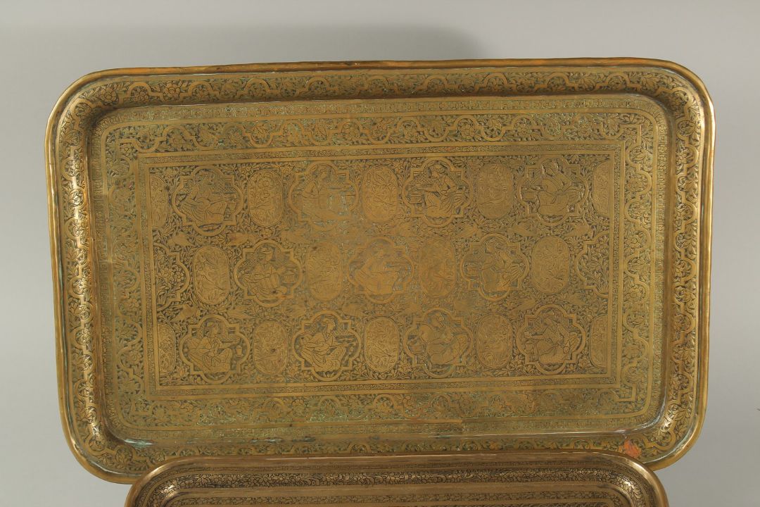 TWO 19TH CENTURY PERSIAN QAJAR ENGRAVED BRASS TRAYS, one depicting seated figures and musicians, the - Image 2 of 3