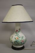 A 19TH CENTURY CHINESE FAMILLE VERTE PORCELAIN VASE CONVERTED TO A LAMP, painted with flora upon a