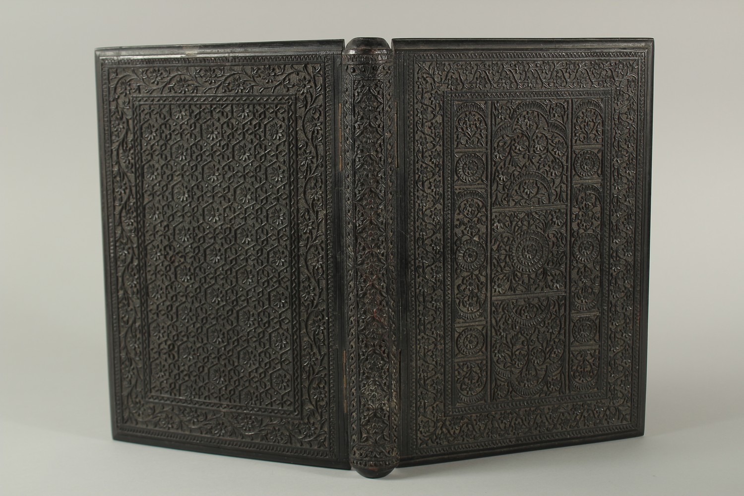 A MID 19TH CENTURY ANGLO INDIAN FINELY CARVED EBONY HINGED BOOK COVER, 30cm x 22cm. - Image 2 of 4