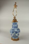 A FINE 19TH CENTURY CHINESE BLUE AND WHITE PORCELAIN OCTAGONAL VASE CONVERTED TO A LAMP, decorated