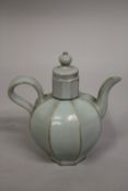 A CHINESE CELADON GLAZE PORCELAIN OCTAGONAL-FORM LIDDED TEAPOT, 19cm high.