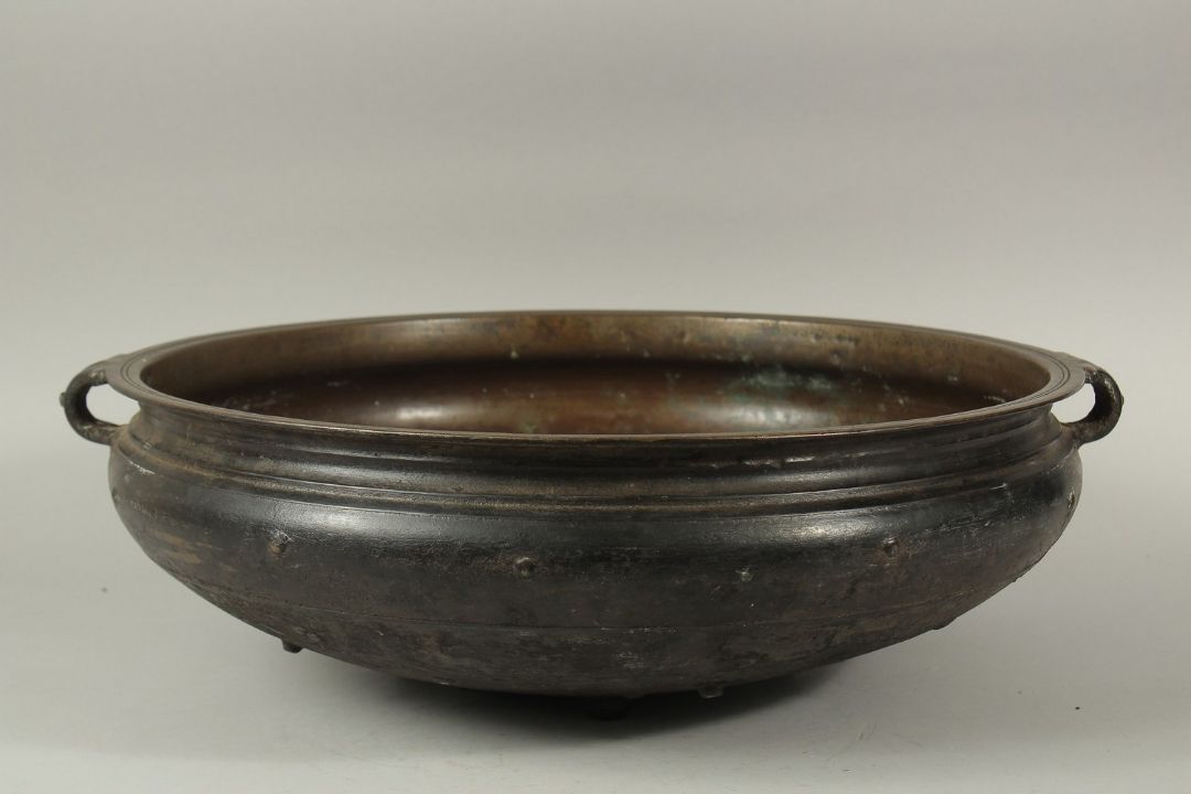 A LARGE 19TH CENTURY INDIAN OR SOUTH EAST ASIAN BRONZE TWIN HANDLE URLI, 59cm diameter. *Note: a - Image 1 of 6