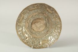 A RARE POSSIBLY EARLY PERSIAN SASSANIAN STYLE WHITE METAL DISH, embossed with animals, 24cm