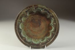A FINE 13TH CENTURY PERSIAN SELJUK ENGRAVED BRASS DISH, depicting a mythical creature in the