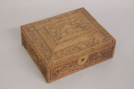 A FINE 19TH CENTURY ANGLO INDIAN SANDELWOOD BOX, with carved panels of architectural scene and