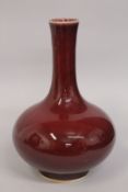 A LARGE CHINESE IRON RED PORCELAIN VASE, the base with character mark, 34cm high.