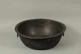 A VERY LARGE AND FINE EARLY ISLAMIC BRONZE BOWL, with twin handles and fine Kufic calligraphy to the